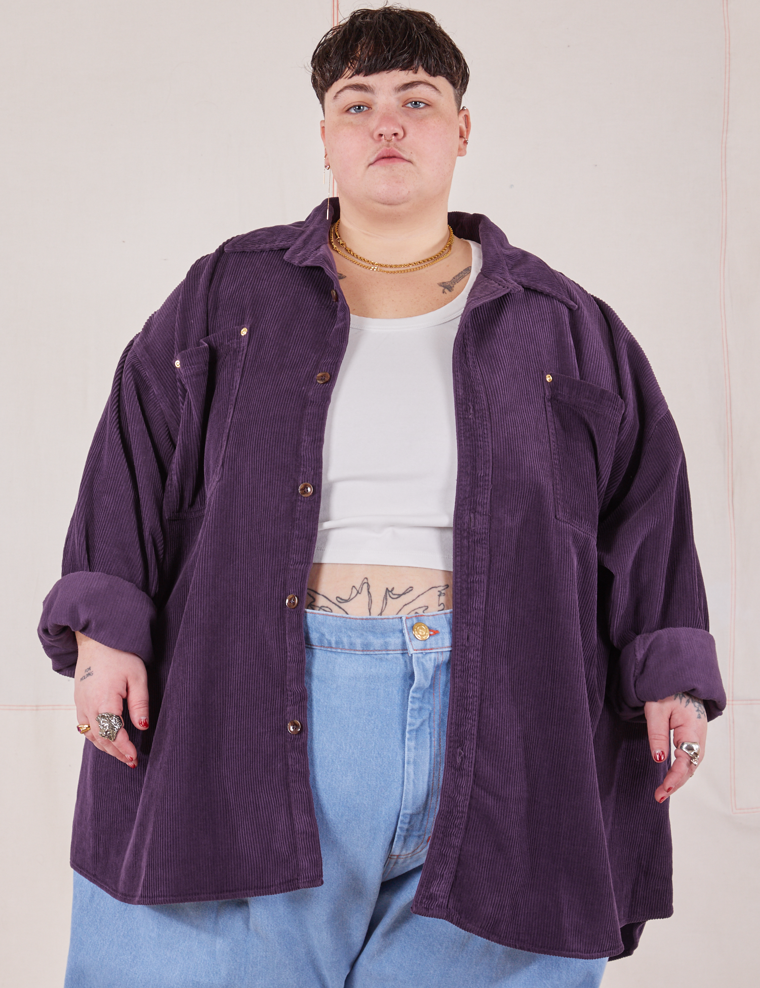 Jordan is 5&#39;4&quot; and wearing 4XL Corduroy Overshirt in Nebula Purple with a vintage off-white Cropped Tank Top underneath paired with a light wash Denim Trouser Jeans