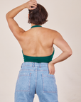 Back view Halter Top in Hunter Green and light wash Sailor Jeans worn by Tiara