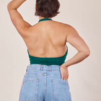 Back view Halter Top in Hunter Green and light wash Sailor Jeans worn by Tiara