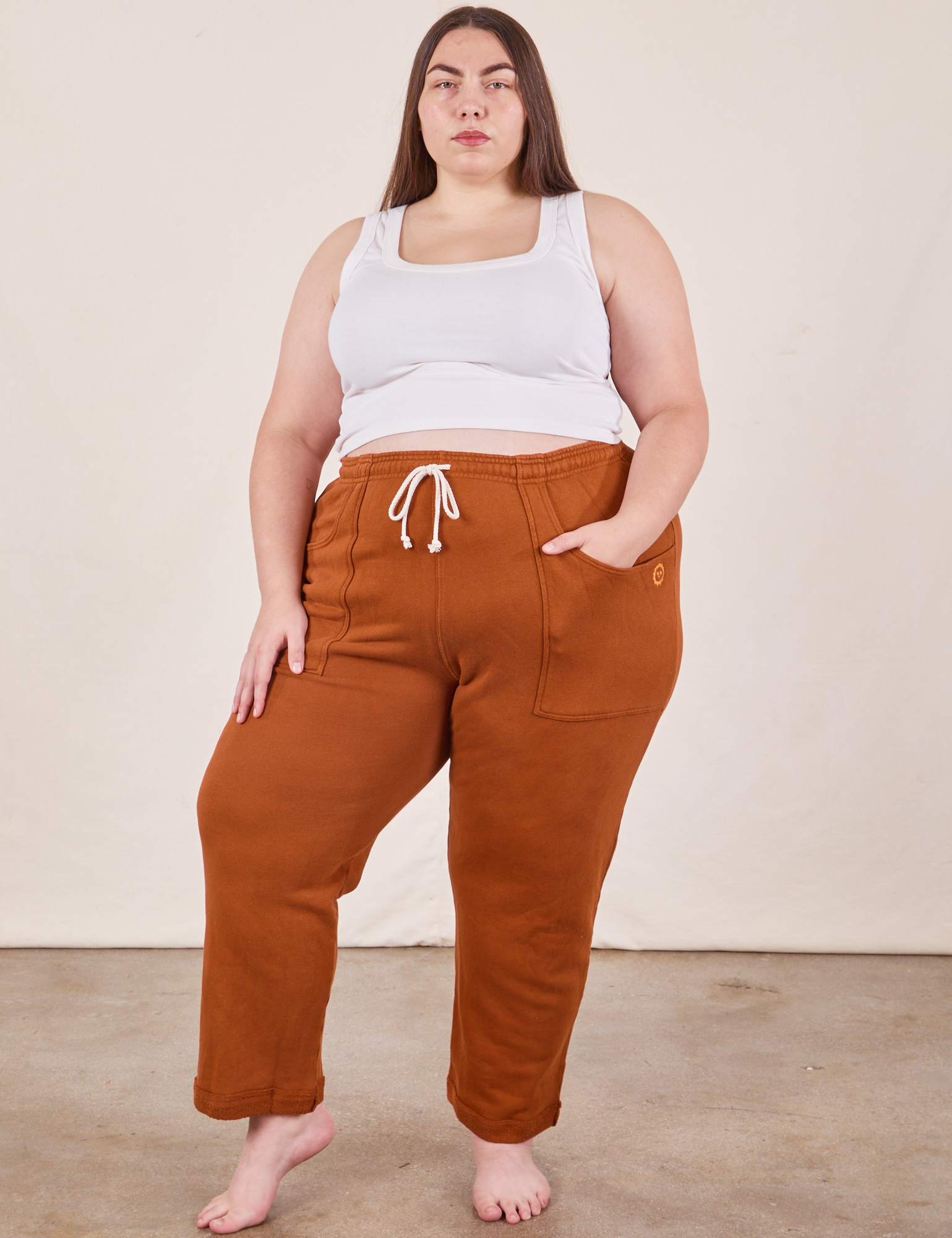 Marielena is 5&#39;8&quot; and wearing 2XL Cropped Rolled Cuff Sweatpants in Burnt Terracotta paired with vintage off-white Cropped Tank Top