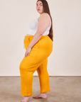 Side view of Cropped Rolled Cuff Sweatpants in Mustard Yellow on Marielena