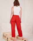 Back view of Heavyweight Trousers in Mustang Red and vintage off-white Sleeveless Turtleneck worn by Alex