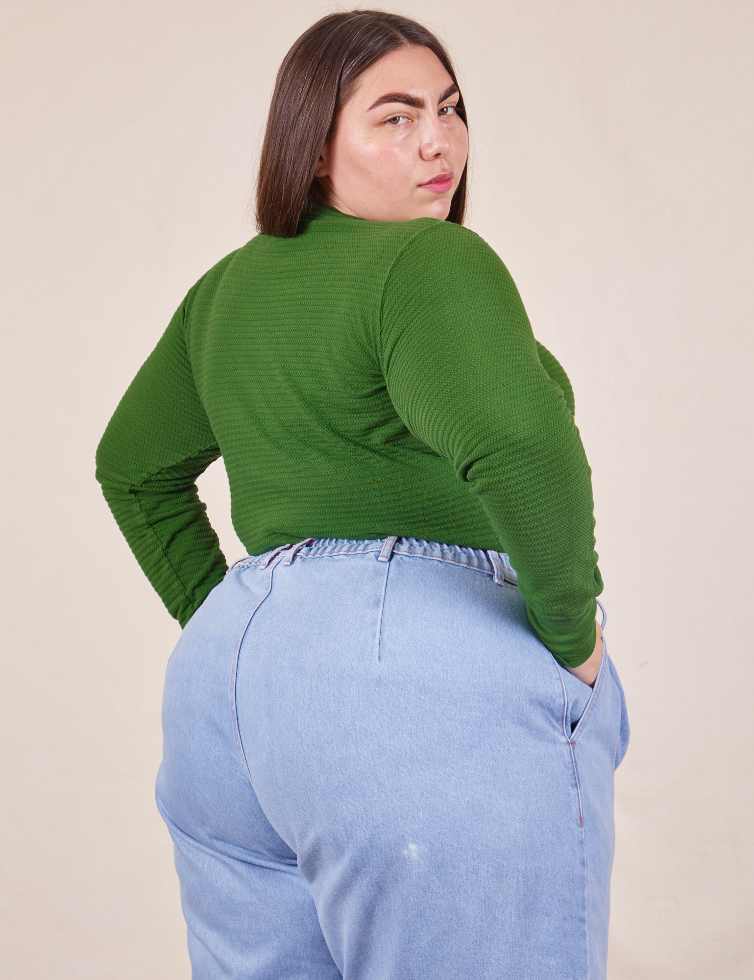 Angled back view of Honeycomb Thermal in Lawn Green worn by Marielena
