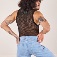 Back view of Mesh Tank Top in Basic Black and light wash Sailor Jeans worn by Jesse