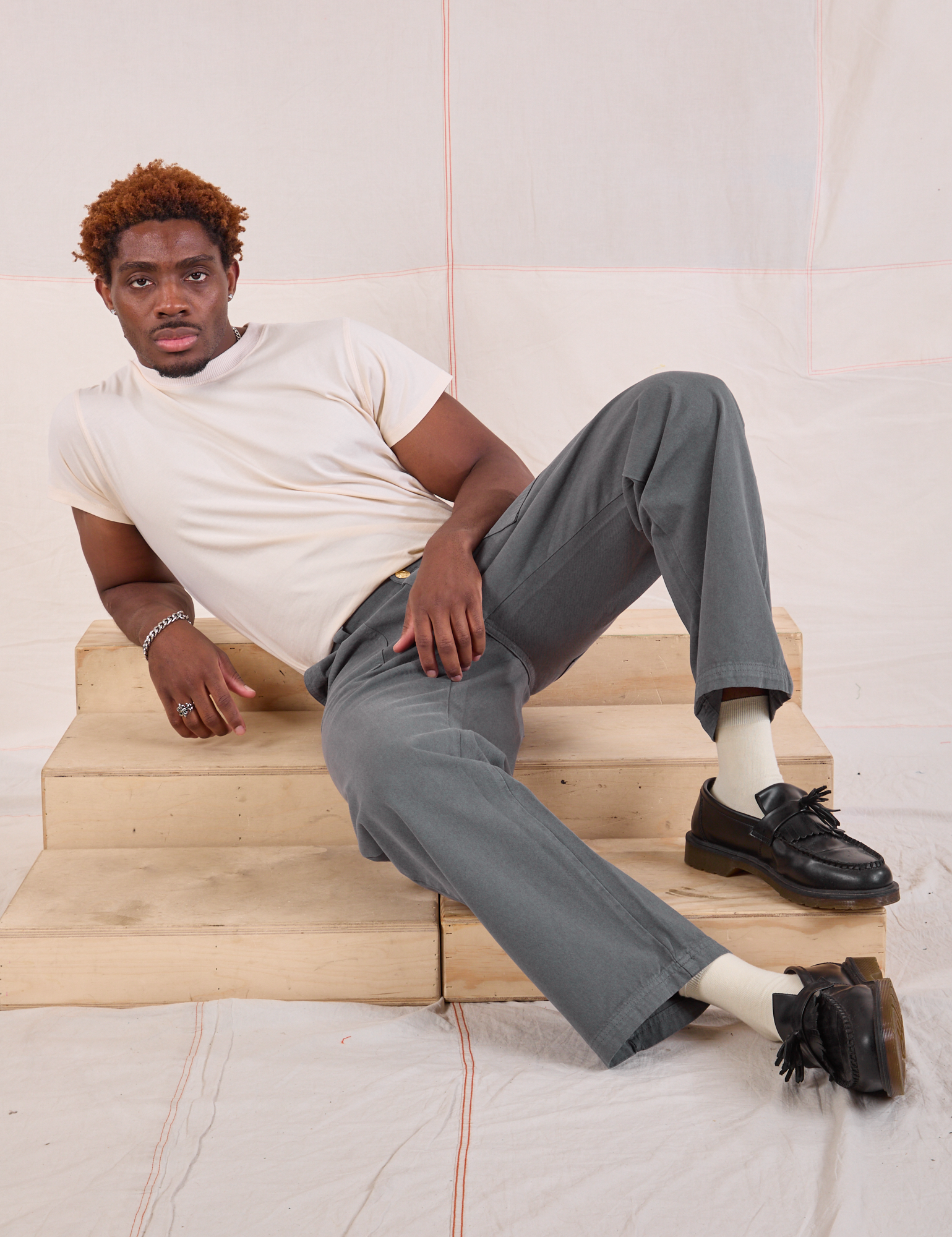 Issac is wearing Mid-Rise Work Pants in Slate Grey and Organic Vintage Tee in vintage tee off-white