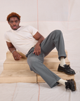 Issac is wearing Mid-Rise Work Pants in Slate Grey and Organic Vintage Tee in vintage tee off-white