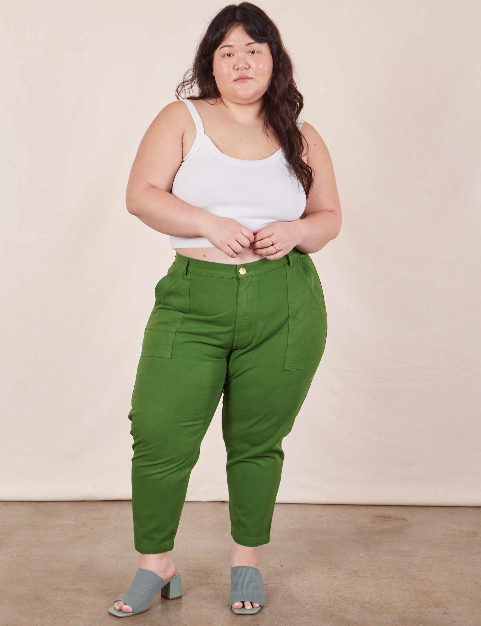 Ashley is 5&#39;7&quot; and wearing 1XL Petite Pencil Pants in Lawn Green paired with vintage off-white Cami