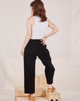 Back view of Denim Trouser Jeans in Black with vintage off-white Cropped Tank Top on Hana