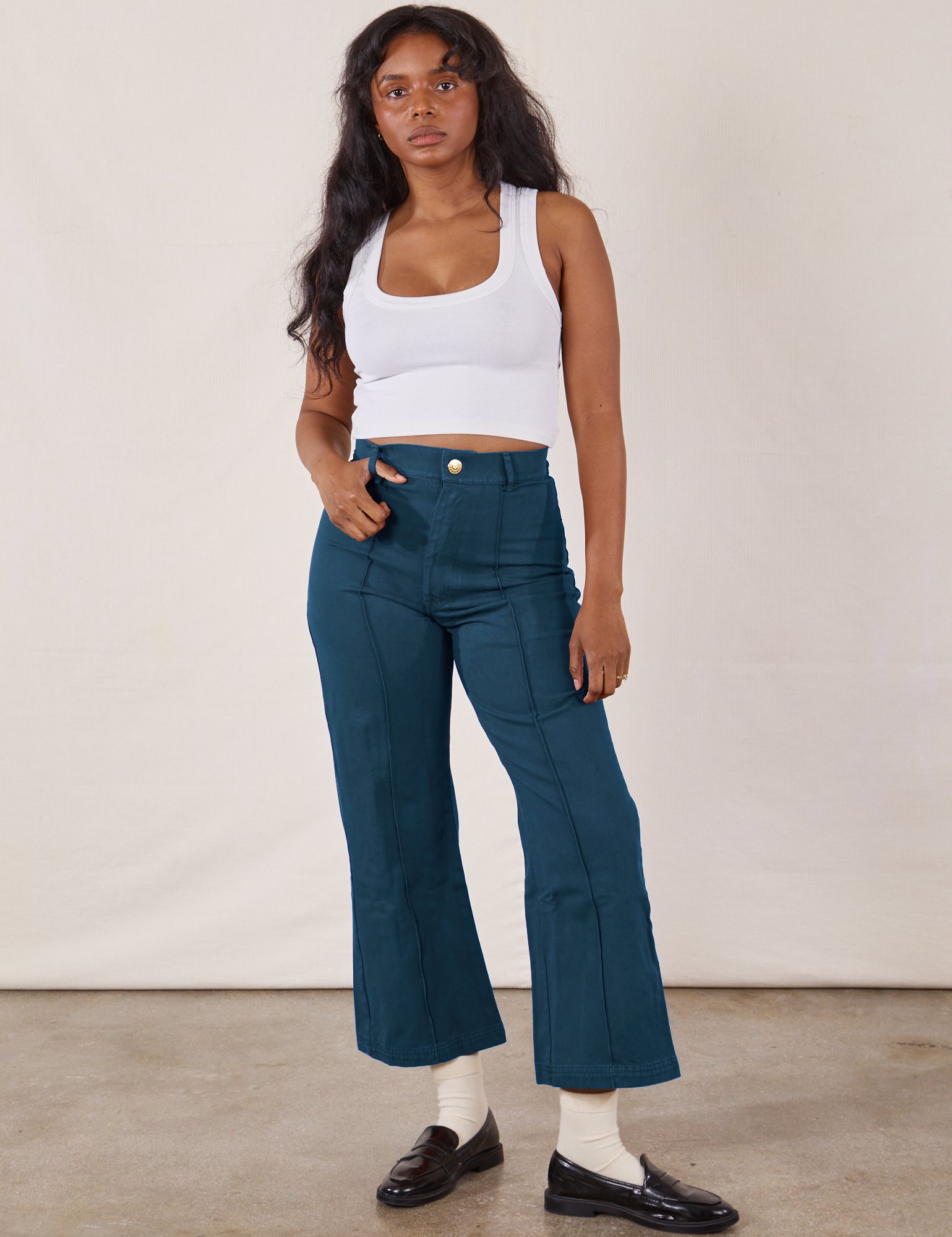 Kandia is 5&#39;4&quot; and wearing XS Petite Western Pants in Lagoon paired with vintage tee off-white Cropped Tank