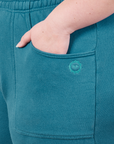 Cropped Rolled Cuff Sweatpants in Marine Blue front pocket close up. Ashley has her hand in the pocket.