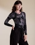 Long Sleeve Baby Tee in Ink Blot angled front view on Alex