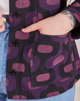  Purple Tile Jacquard Work Jacket front pocket close up. Sydney has her hand in the pocket.