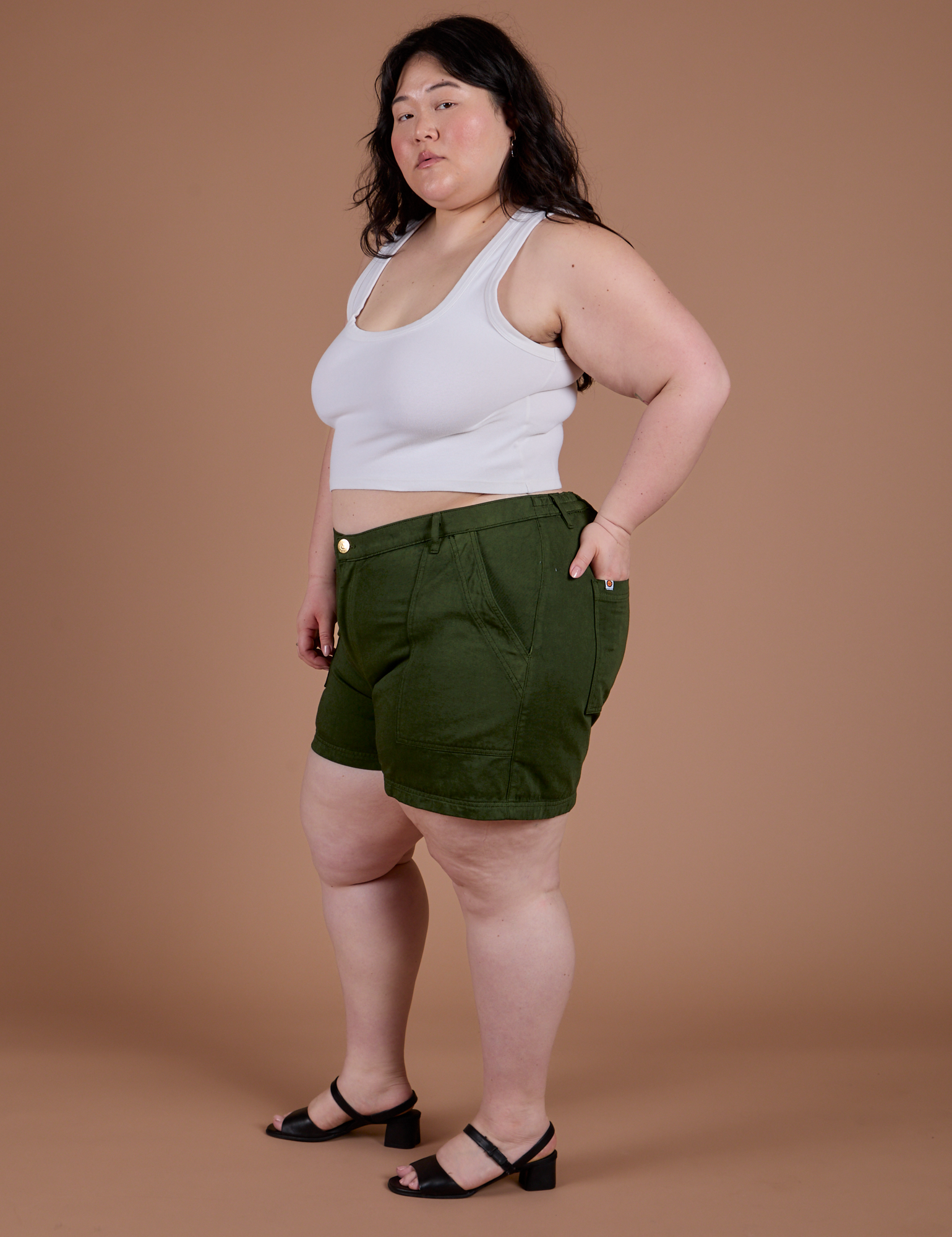 Side view of Classic Work Shorts in Evergreen and Cropped Tank in Vintage Tee White on Ashley