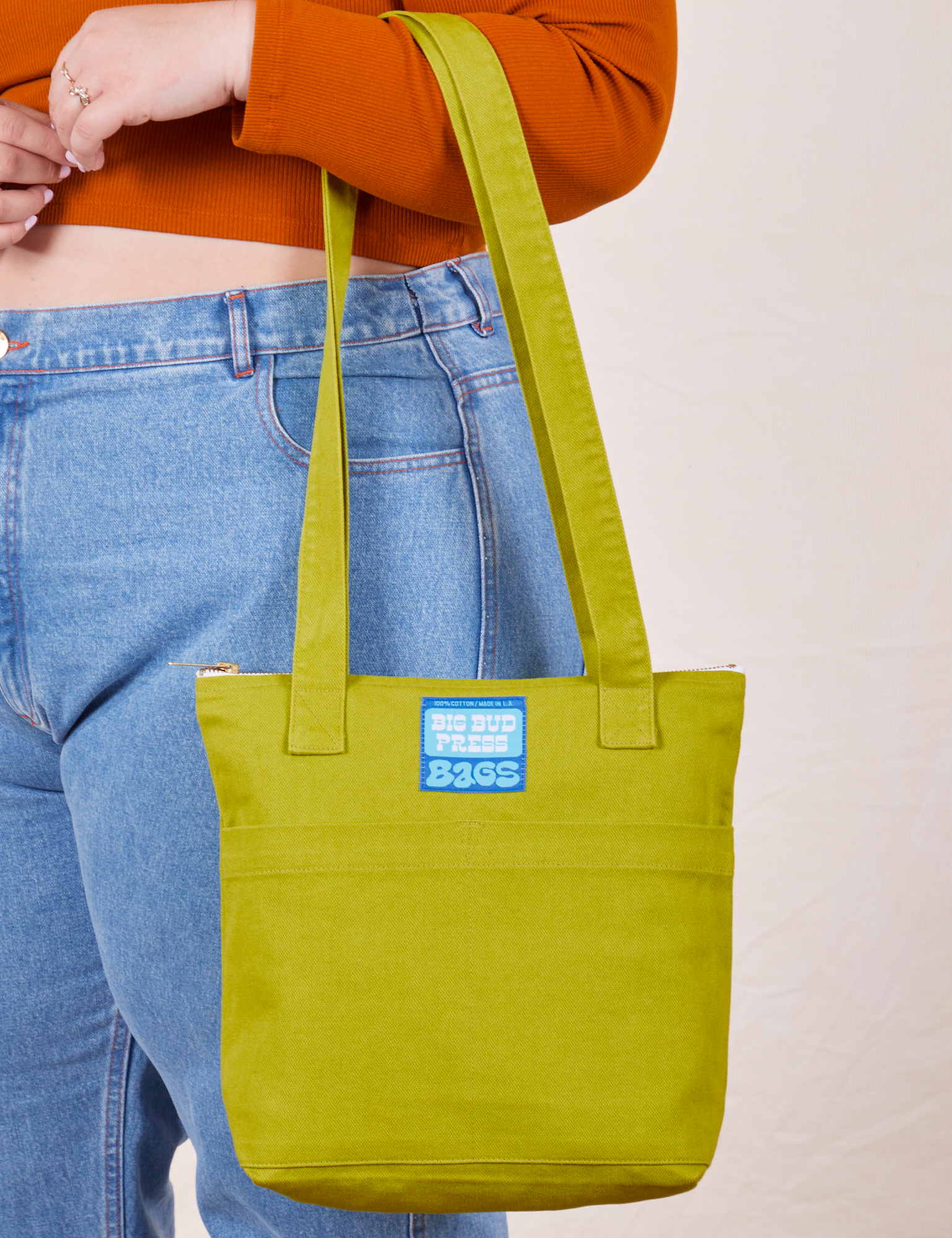 Over-Shoulder Zip Mini Tote in Gross Green worn on arm of model