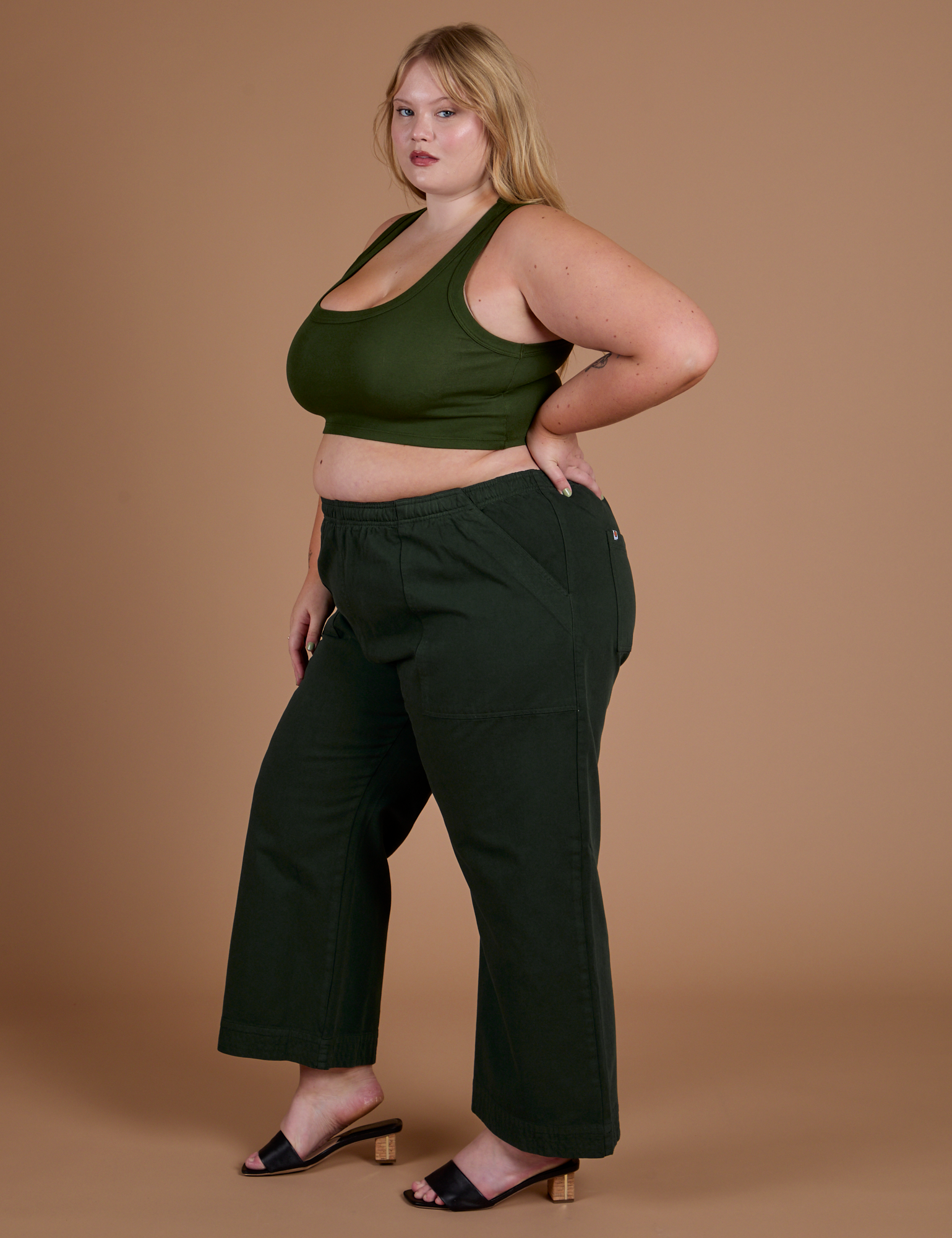 Side view of Action Pants in Swamp Green and evergreen Mini Tank on Juliet