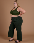 Side view of Action Pants in Swamp Green and evergreen Mini Tank on Juliet