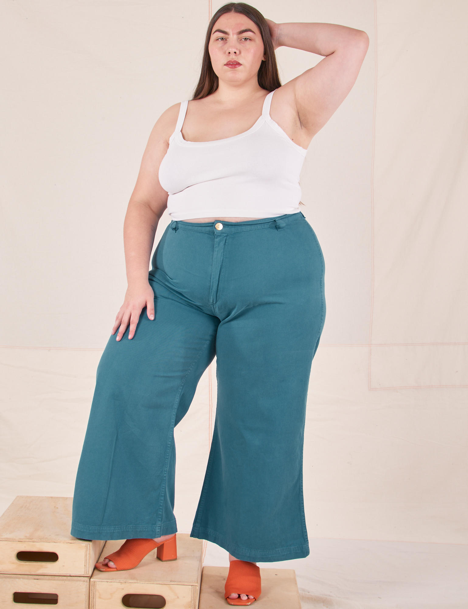 Marielena is wearing Bell Bottoms in Marine Blue and vintage off-white Cropped Cami