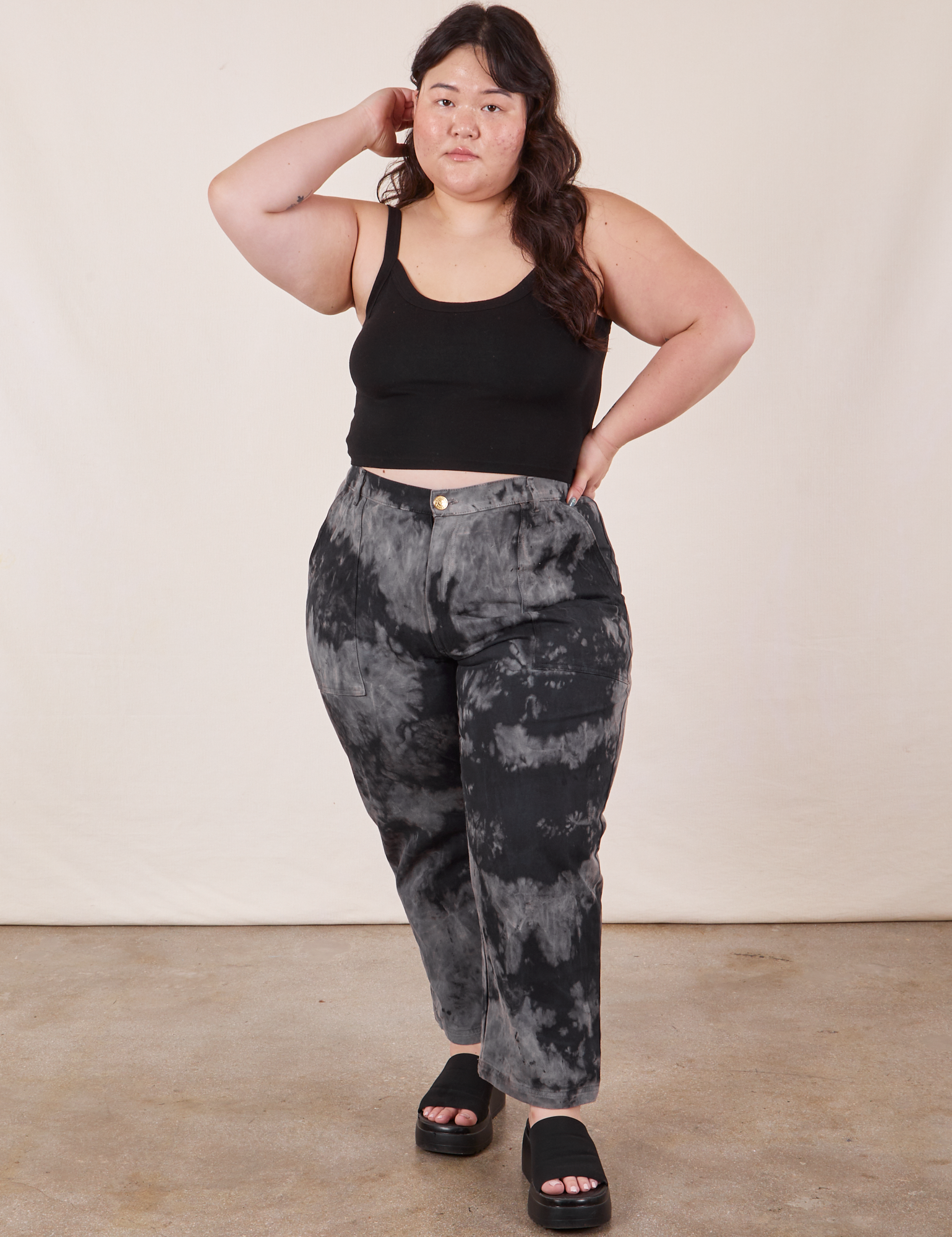 Ashley is 5&#39;7&quot; and wearing 1XL Petite Black Magic Waters Work Pants paired with black Cropped Cami