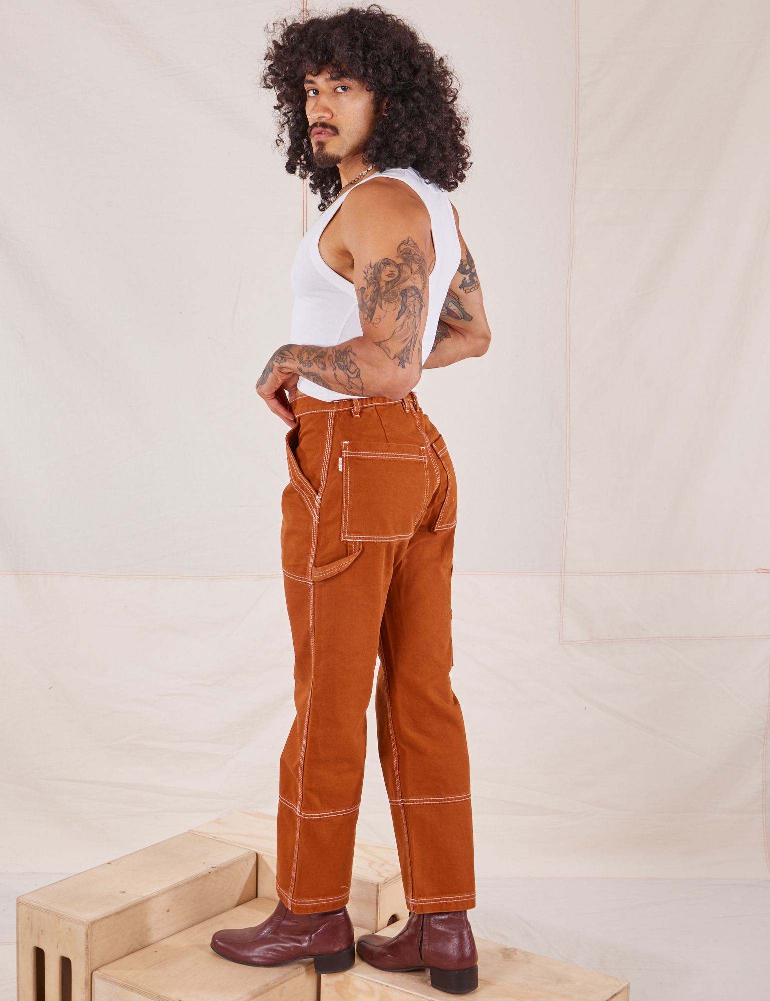 Angled back view of Carpenter Jeans in Burnt Terracotta on Jesse