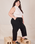 Side view of Heavyweight Trousers in Basic Black and vintage off-white Sleeveless Turtleneck worn by Ashley.