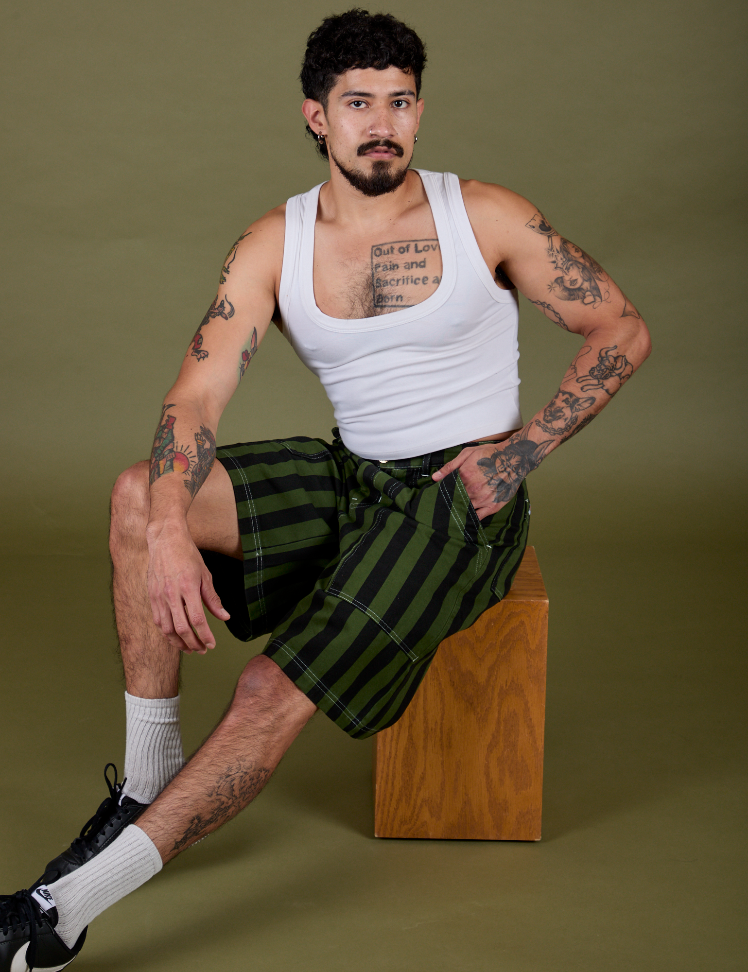 Jesse is wearing  Longline Work Shorts in Evergreen and vintage tee white Cropped Tank