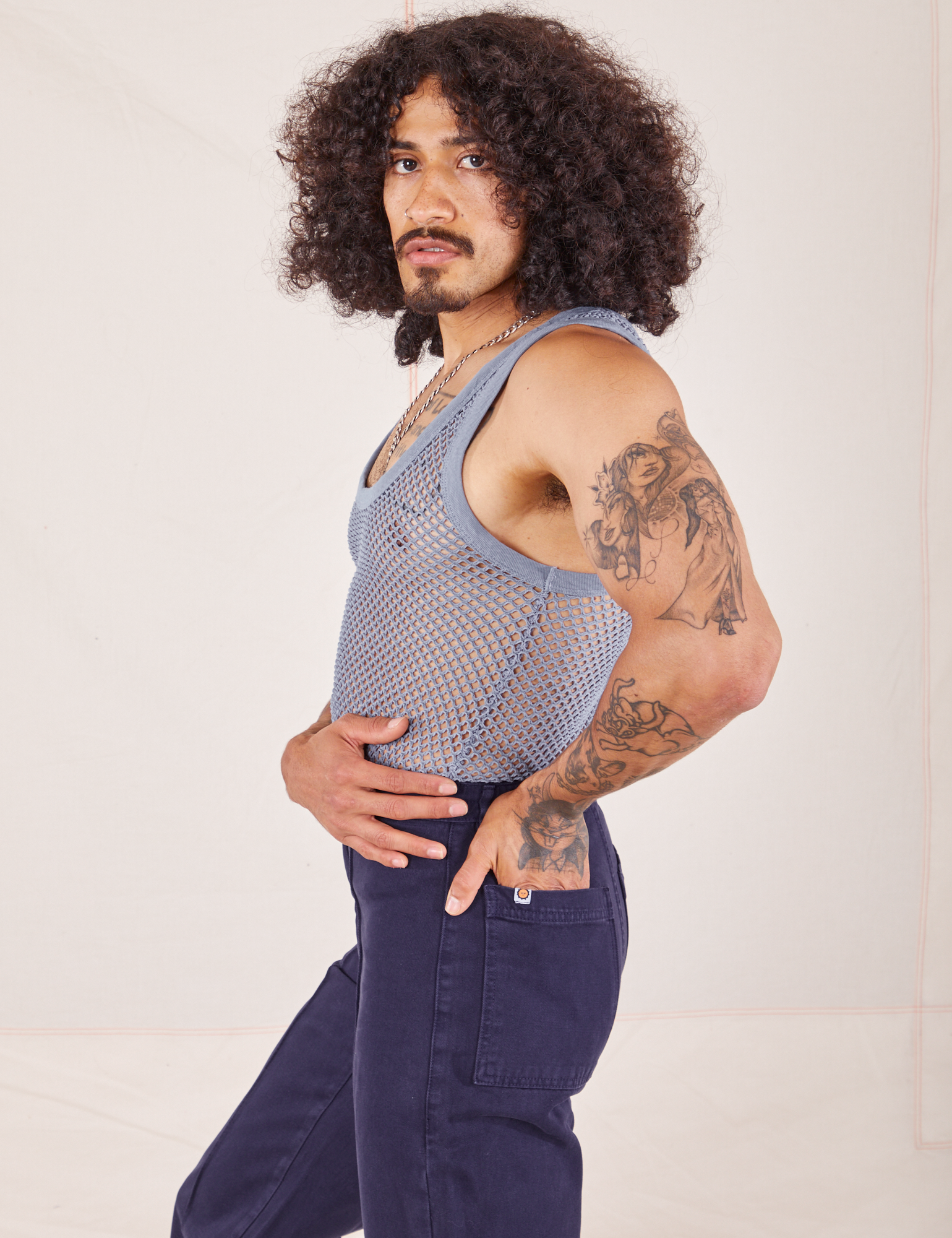 Side view of Mesh Tank Top in Periwinkle and navy Western Pants worn by Jesse