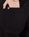 Petite Pencil Pants in Basic Black back pocket close up. Hana has her hand in the pocket.