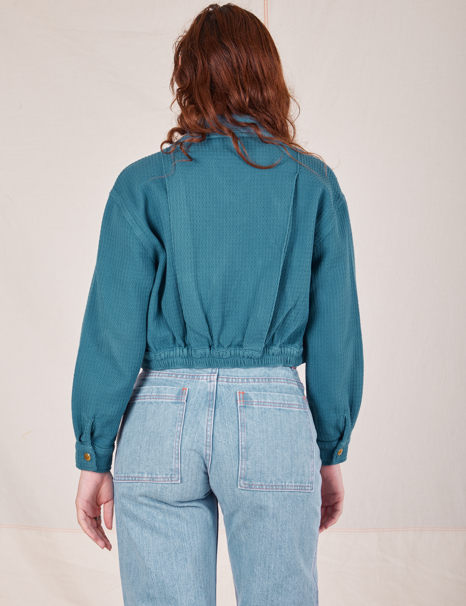 Back view of the Ricky Jacket in Marine Blue worn by Alex