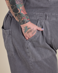 Close up of Sam's hand in the front pocket of Short Sleeve Jumpsuit in Washed Grey