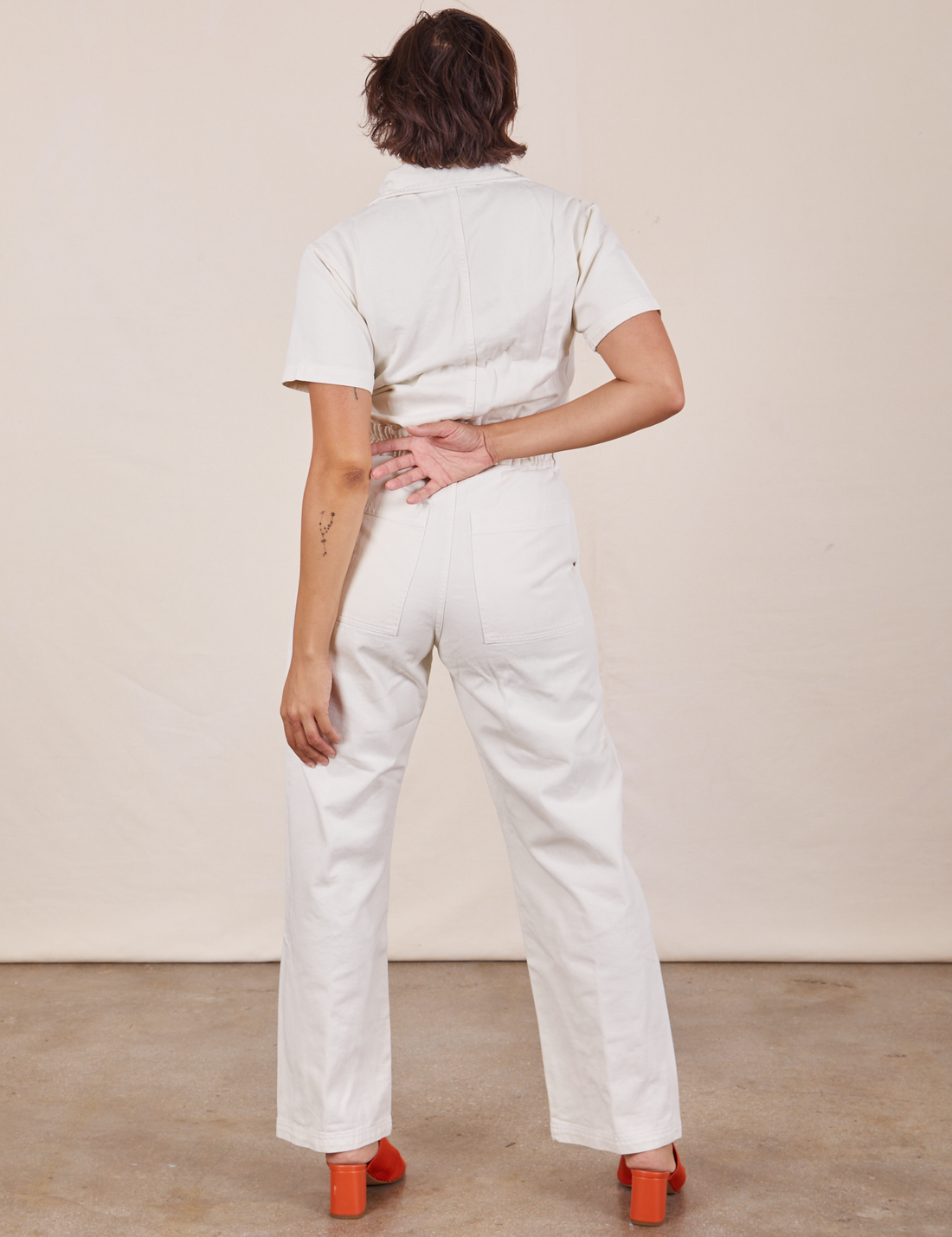 Back pocket close up of Short Sleeve Jumpsuit in Vintage Tee Off-White worn by Tiara