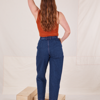 Back view of Denim Trouser Jeans in Dark Wash and burnt orange Tank Top worn by Allison