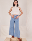 Betty is wearing Indigo Wide Leg Trousers in Light Wash and vintage off-white Sleeveless Turtleneck