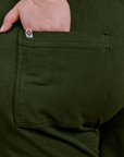 Close up of Ashley's hand in the back pocket of Classic Work Shorts in Evergreen