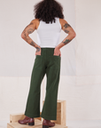 Back view of Action Pants in Swamp Green and Cropped Tank in vintage tee off-white worn by Jesse