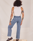 Back view of Carpenter Jeans in Railroad Stripes and vintage off-white Tank Top worn by Jesse