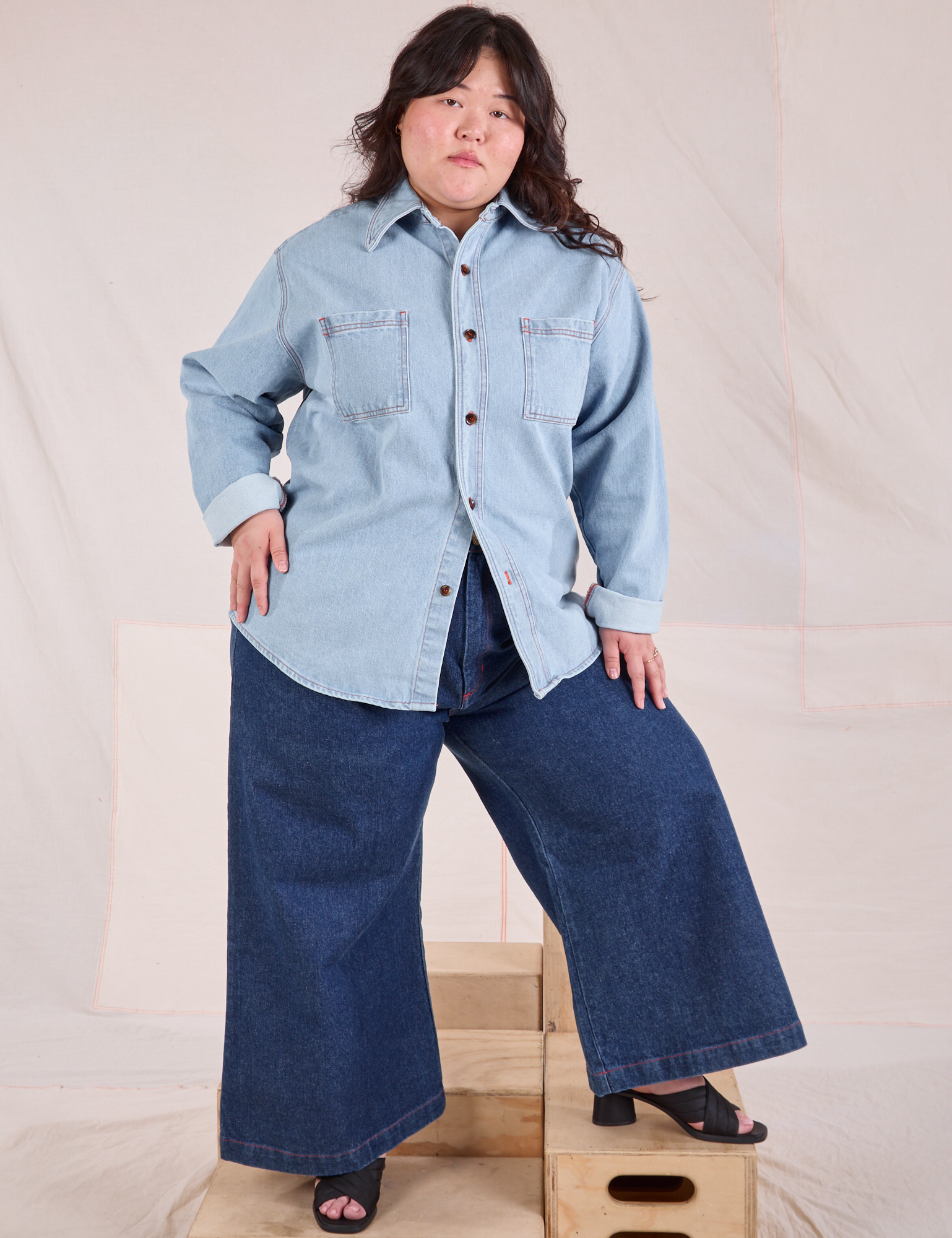 Ashley is wearing a buttoned up Denim Overshirt in Light Wash and dark wash Wide Leg Trouser Jeans