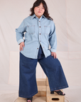 Ashley is wearing a buttoned up Denim Overshirt in Light Wash and dark wash Wide Leg Trouser Jeans