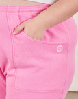 Cropped Rolled Cuff Sweatpants in Bubblegum Pink front pocket close up. Marielena has her hand in the pocket.
