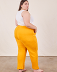 Angled back view of Cropped Rolled Cuff Sweatpants in Mustard Yellow on Marielena