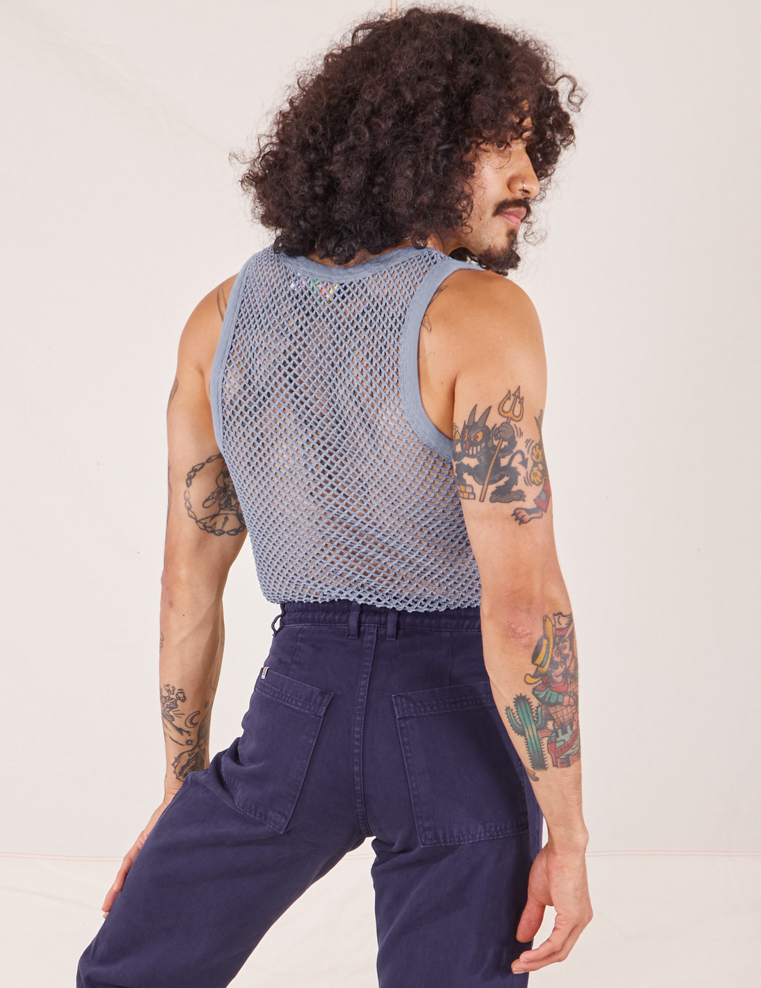 Back view of Mesh Tank Top in Periwinkle and navy Western Pants worn by Jesse