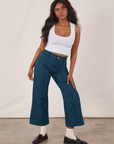 Kandia is wearing Petite Western Pants in Lagoon and vintage tee off-white Cropped Tank