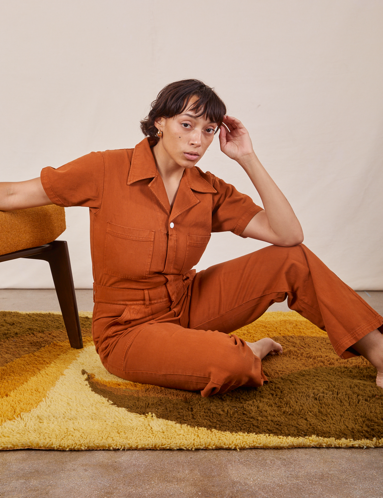 Tiara is wearing Short Sleeve Jumpsuit in Burnt Terracotta