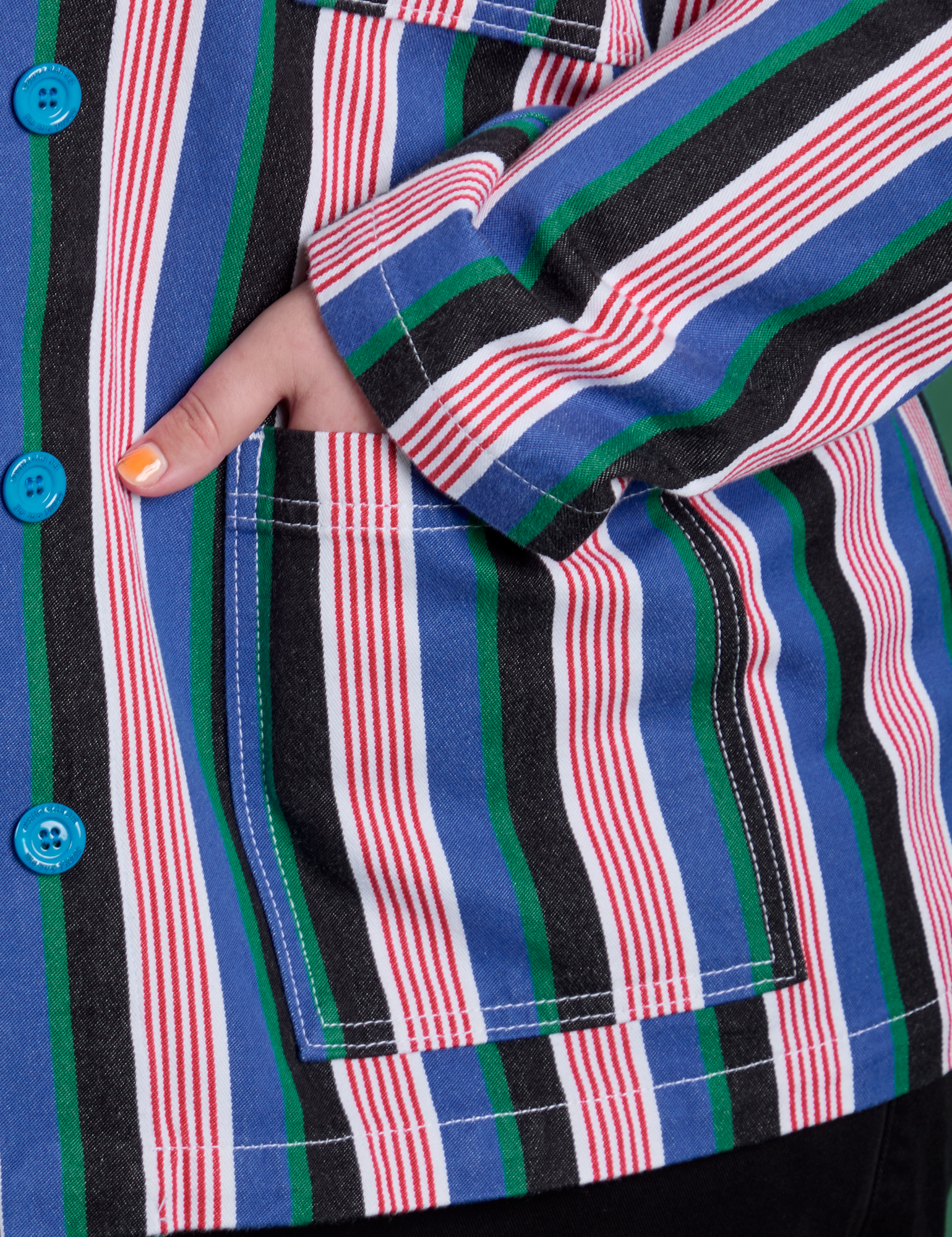 Close up of Juliet's hand in the front pocket of Stripe Work Jacket in Pacific Stripe