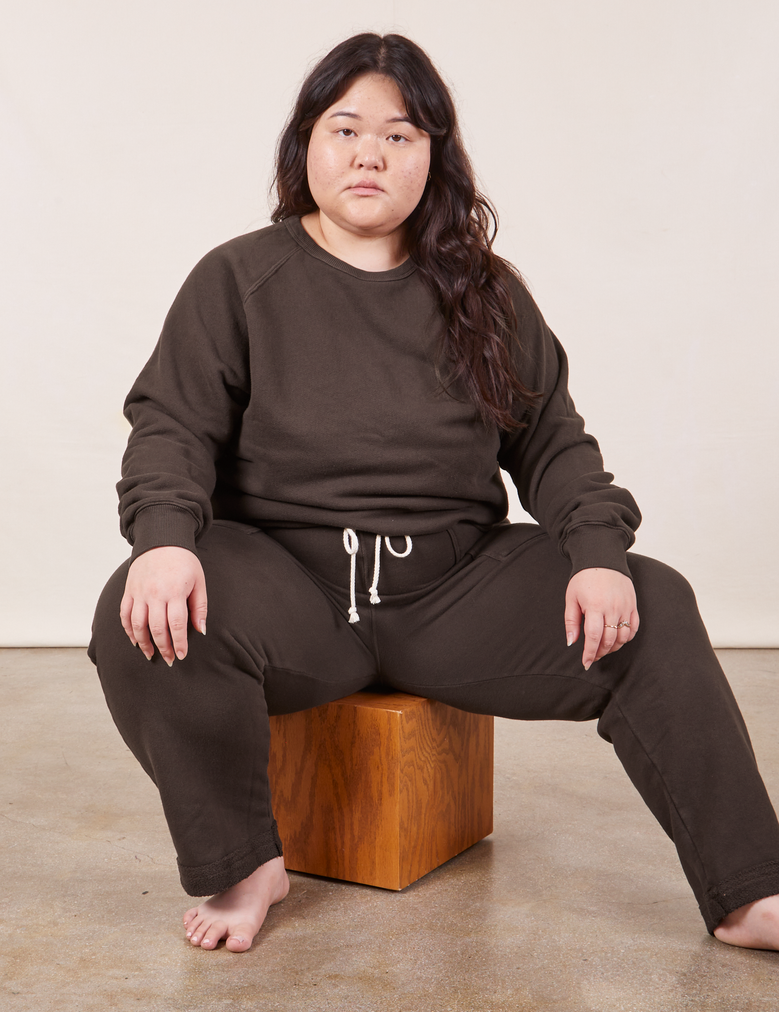 Ashley is wearing Heavyweight Crew in Espresso Brown and Cropped Rolled Cuff Sweatpants