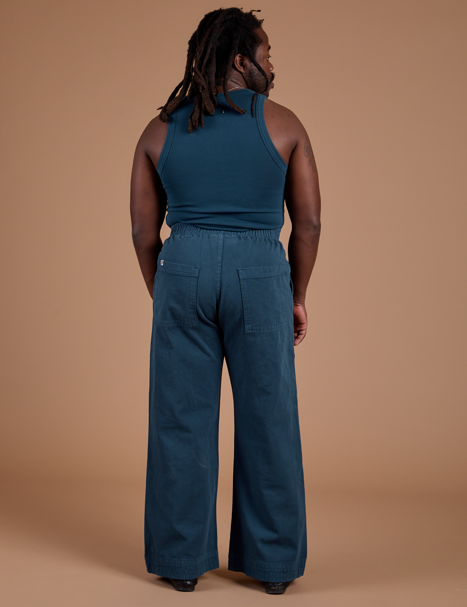 Back view of Action Pants in Lagoon and lagoon Tank Top on Demi