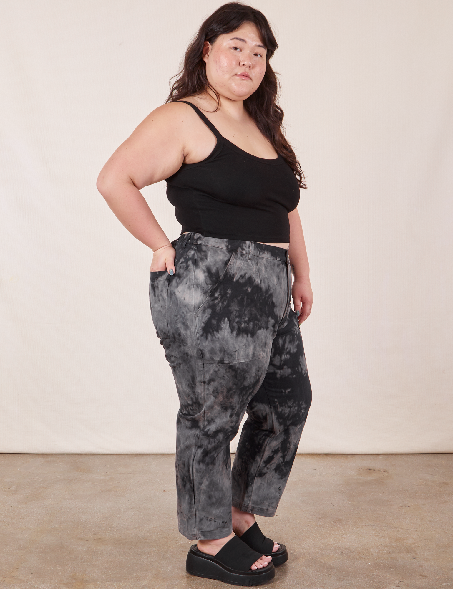 Side view of Black Magic Waters Work Pants and black Cropped Cami worn by Ashley