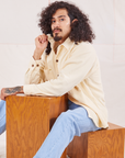 Jesse is wearing Corduroy Overshirt in Vintage Off-White and light wash Denim Trouser Jeans