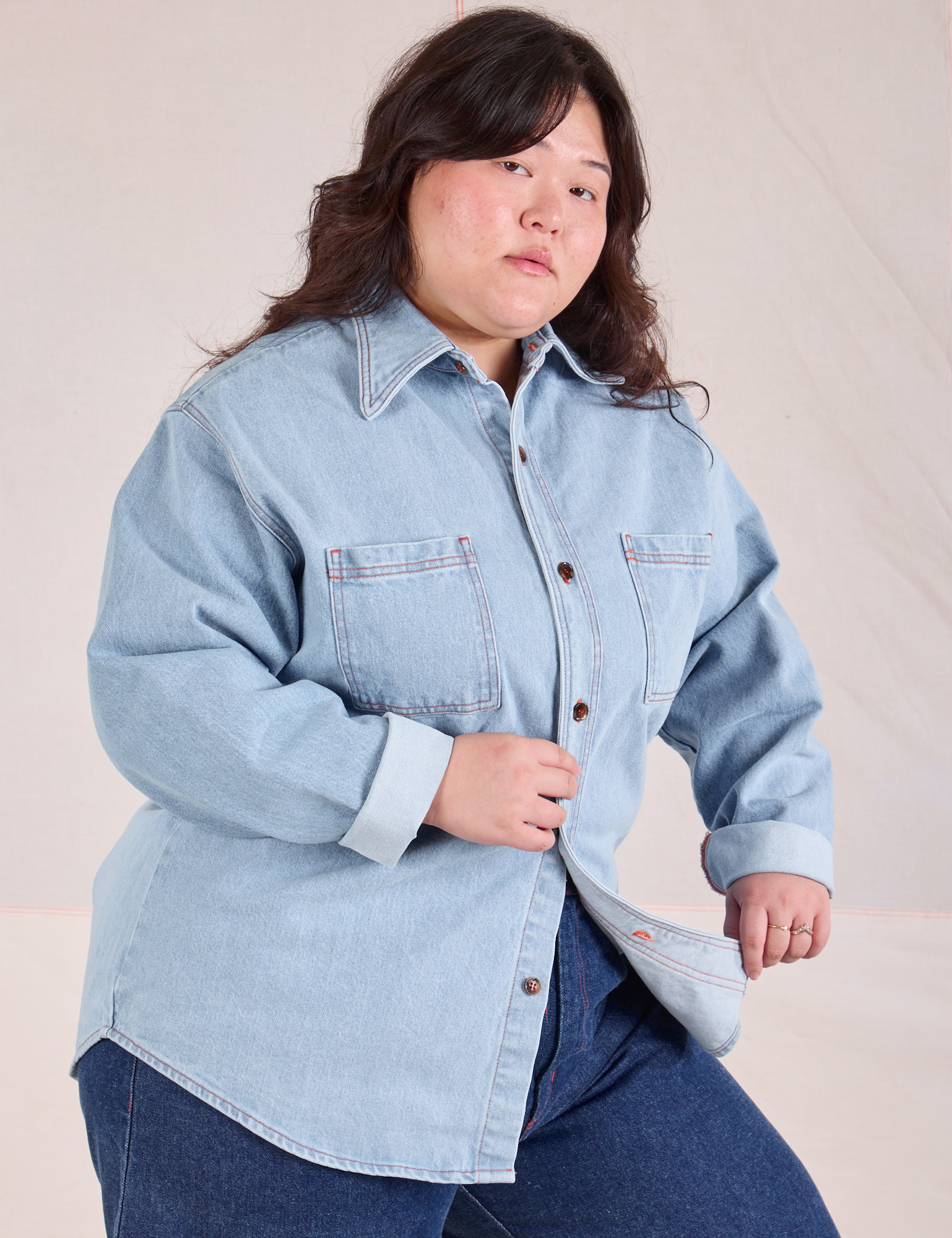 Ashley is wearing a buttoned up Denim Overshirt in Light Wash