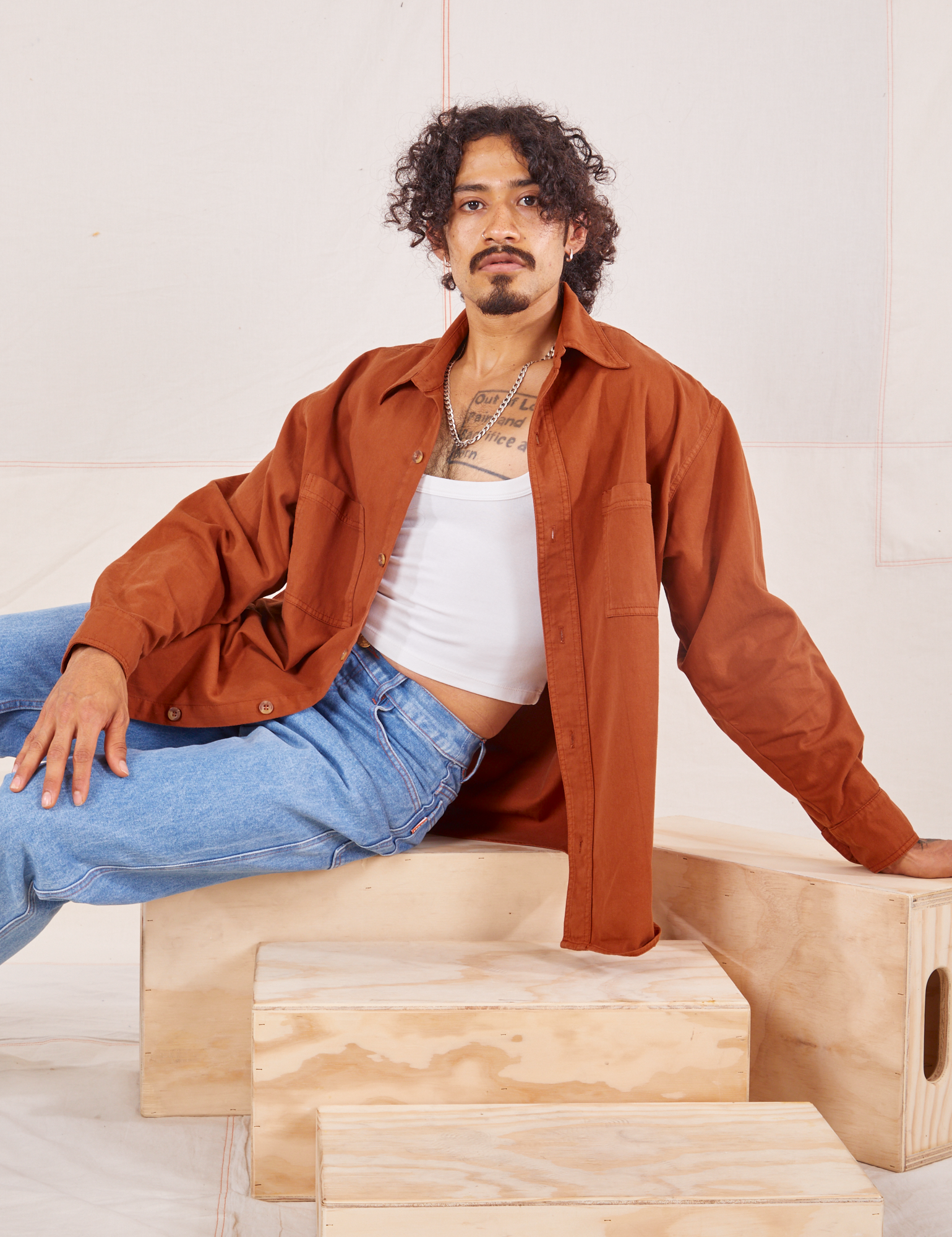 Jesse is wearing Oversize Overshirt in Burnt Terracotta paired with vintage off-white Cropped Tank Top