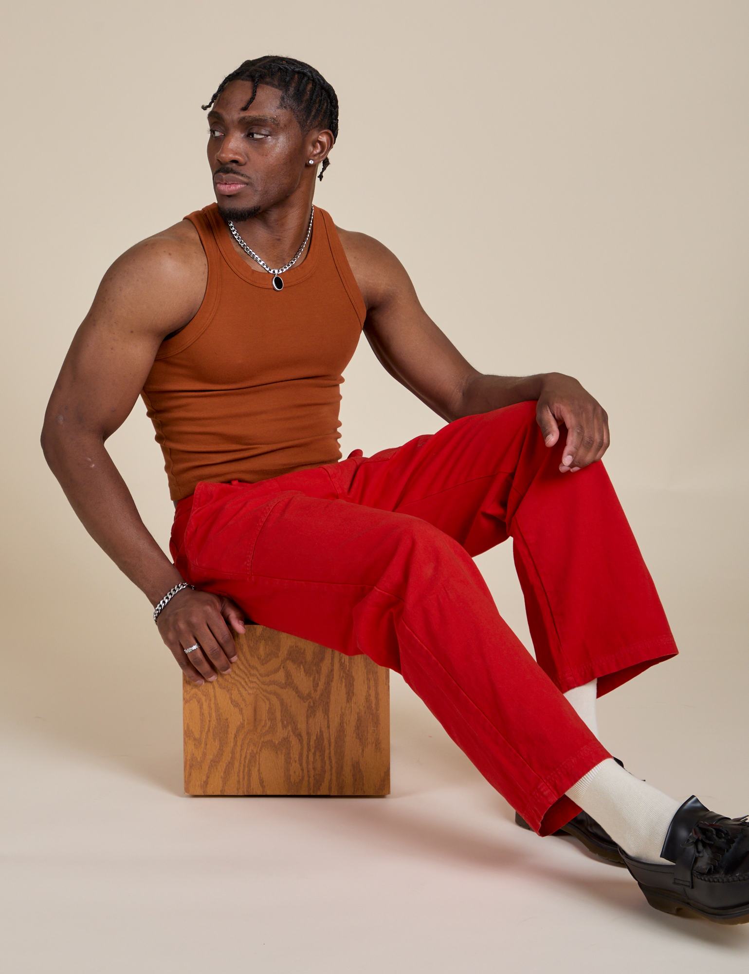Racerback Tank in Burnt Terracotta and Work Pants in Mustang Red worn by Isaac